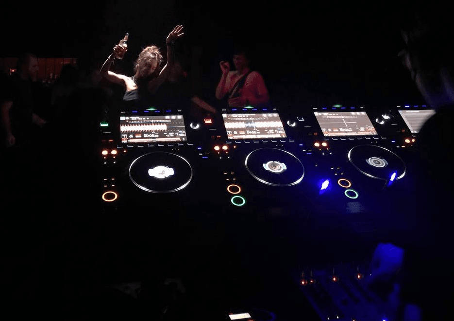 DJ playing in the club for people dancing